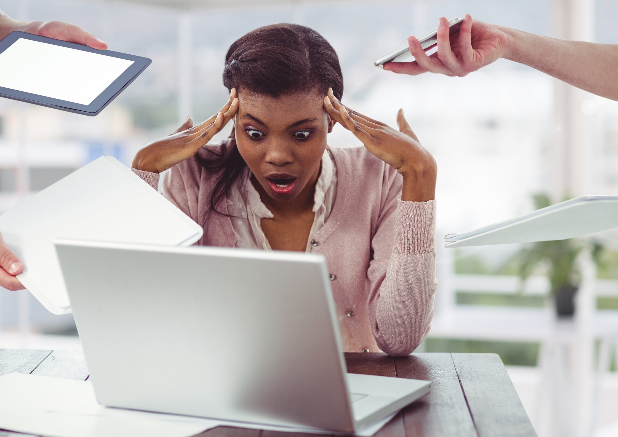 Digital composition of stressed businesswoman sitting with laptop and people holding electronic devices around her